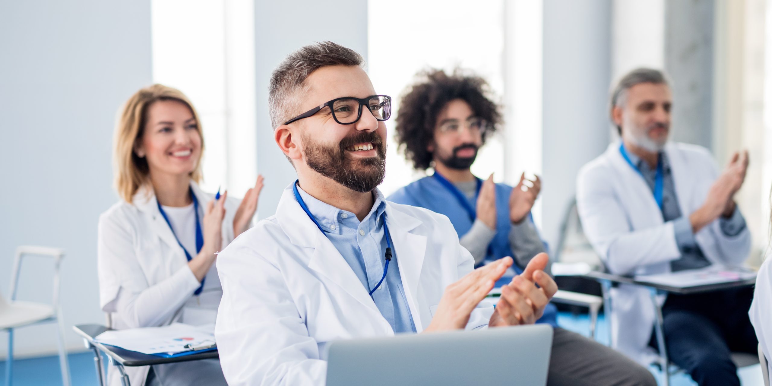 Group of doctors listening to presentation on medical conference.